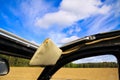 View through open folding roof and windows of classic French cabriolet car 2cv beyond a-pillar, rearview mirror and sun shield on Royalty Free Stock Photo