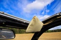 View through open folding roof and windows of classic French cabriolet car 2cv beyond a-pillar, rearview mirror and sun shield on Royalty Free Stock Photo