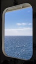 View of the open sea through the porthole of an external cabin Royalty Free Stock Photo