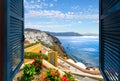 View through an open window of the Aegean Sea, caldera and town of Oia and Thira on the island of Santorini Greece Royalty Free Stock Photo