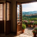 View through an open window with shutters and a flowerbox out over the Tuscan countryside and medieval hilltop old