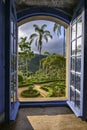 View through an open window to a park with walkways and palm trees, Caraca, Minas Gerais, Brazil