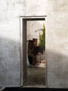 View through opening on concrete wall into courtyard Royalty Free Stock Photo