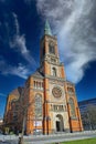 View on orange color church facade from 18th century in romanesque revival style against blue sky
