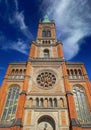 View on orange color church facade from 18th century in romanesque revival style against blue sky