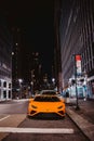 View of an orange luxury Lamborghini car parked on a street
