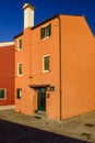 View of an orange and one red house, Pellestrina island, Venetian lagoon, Italy Royalty Free Stock Photo