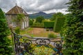 View on the orangerie and the surrounding landscape from the garden of Plas Brondanw, North Wales