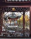 A view of the oriental style gazebo through wooden window at the Lan Yuan Chinese gardens in Dunedin, New Zealand
