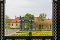 A view through the ornamental gate into the garden of the baroque SchÃ¶nbrunn Palace of the Austrian Emperors.