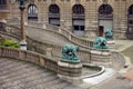 Exterior Stairs of Louvre Museum with Sculptures of Guard Animals at Bottom of Steps