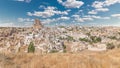 View of Ortahisar town old houses in rock formations from Ortahisar Castle aerial timelapse.