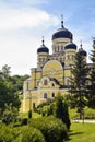 View of Orthodox Cathedral with domes in monastery against background of green landscape and cloudy sky. Hincu Monastery Royalty Free Stock Photo