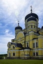 View of Orthodox Cathedral with domes in monastery against background of green landscape and cloudy sky. Hincu Monastery Royalty Free Stock Photo
