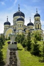 View of Orthodox Cathedral with domes in monastery against background of green landscape and cloudy sky. Hincu Monastery Royalty Free Stock Photo