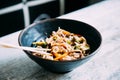 View osf asian noodles udon with pork close-up in a bowl on the table