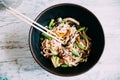 View osf asian noodles udon with pork close-up in a bowl on the table. Flat view