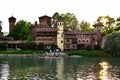 View from the other side of the Valentino castle, Seeing the reflection of the sun on the water and several canoeists on the river Royalty Free Stock Photo