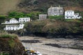 The view from the other side of the water of Doc Martin`s home and Burt and Al Large`s restaurant on the hill with other houses.