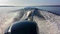 View of the Ottawa River from a motorboat, leaving a picturesque spray and foam fan on the blue water Royalty Free Stock Photo