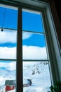 View out the window of snow capped mountains on a cold winters day. Royalty Free Stock Photo