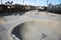 View of outdoor empty concrete skate park with ramps and pipes in California. Skate Parks are a great place for kids to do tricks