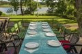 View of outdoor party table covered with sea green table cloth ready served. Beautiful nature around.