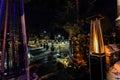 View of outdoor propane heater turned on against backyard background decorated with various lights at winter time