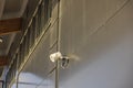 View of outdoor speaker and public safety surveillance camera on gray wall. Royalty Free Stock Photo