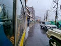 view outside toy train in darjeeling shimla showing the wet street and cars moving on the road showing this famous