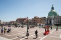 View outside Venice train station, tourists walking nearby on a hot summer day