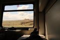 The view outside a window from the bed in the sleeping compartment, passenger cabin on the train ride in the Eastern Express, Dogu