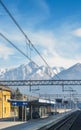 View from outside window of train at small train station and majestic Italian Alps Royalty Free Stock Photo