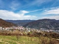 Houses and mountains under a blue cloudy sky. Caucasus mountains. Royalty Free Stock Photo