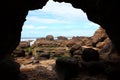 Inside the cavern of Caves Beach, rocky landscape by low tide