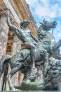 View over ancient Roman statue of beautiful young Amazonian man rider with spear on horse being attacked by lion at Altes History Royalty Free Stock Photo