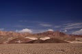 View over barren plain on brown hills contrasting with deep blue sky - Salar Salt flat near San Pedro de Atacama - Chile Royalty Free Stock Photo