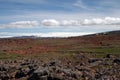 View over barren rocky plain on mountain range with spots of snow, Iceland Royalty Free Stock Photo
