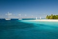 View over beautiful bay to palms and beach of Palm Island. White sand, turquoise sea, boats on water and blue sky. Royalty Free Stock Photo