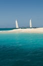 View over beautiful bay to palms and beach of Palm Island. White sand, turquoise sea, boats on water and blue sky. Royalty Free Stock Photo