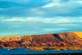View over blue lake water on dry barren mountains in evening sunlight - Lake Powell, USA Royalty Free Stock Photo