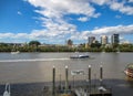 View over Brisbane River from Eagle Street pier with sailboats and CityCat catamaran passing and West Royalty Free Stock Photo