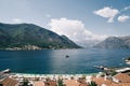 View over the brown roofs of hotels to a boat sailing on the sea