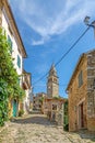 View over the cobblestone historic access road to Motovun with evangelical church during the day