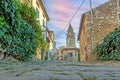 View over the cobblestone historic access road to Motovun with evangelical church during the day