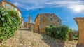 View over the cobblestone historic access road to Motovun with evangelical church during the day