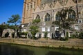 View over dutch water canal on residential houses with gothic church background against blue summer sky - Dordrecht, Netherlands Royalty Free Stock Photo