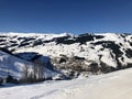 View over empty skiing slopes down in the valley of Saalbach-Hinterglemm