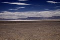 View over endless dried barren land on blurred mountain range in the horizon Royalty Free Stock Photo