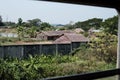 View over a few wooden houses from a window of the moving circle train in Yangon Royalty Free Stock Photo